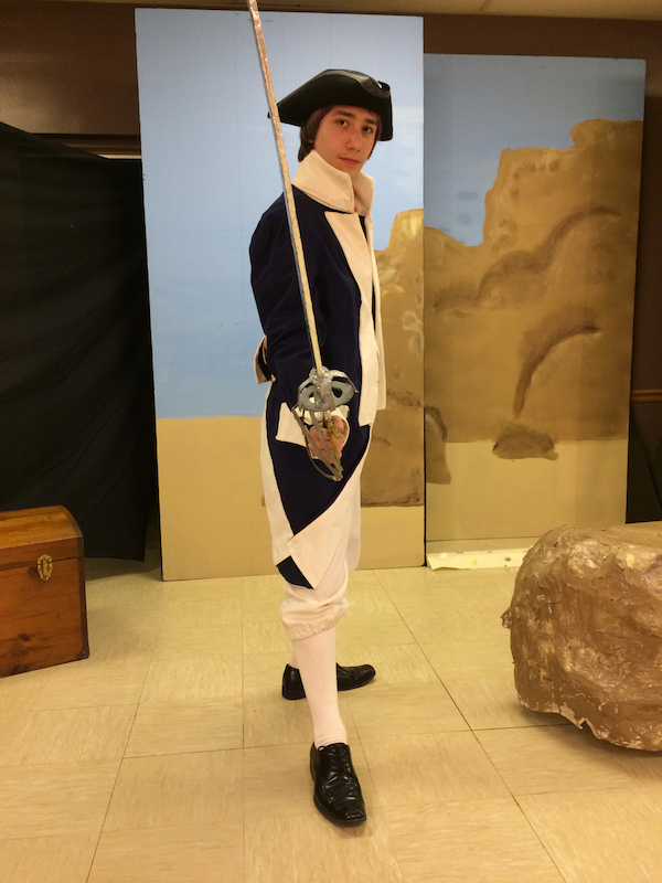 Planet Homeschool student in police officer costume for 2017 PHS Pirates of Penzance production. Used with parental and student permission.