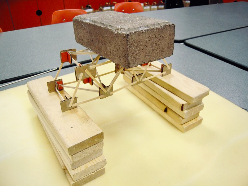 a brick rests atop a bridge model