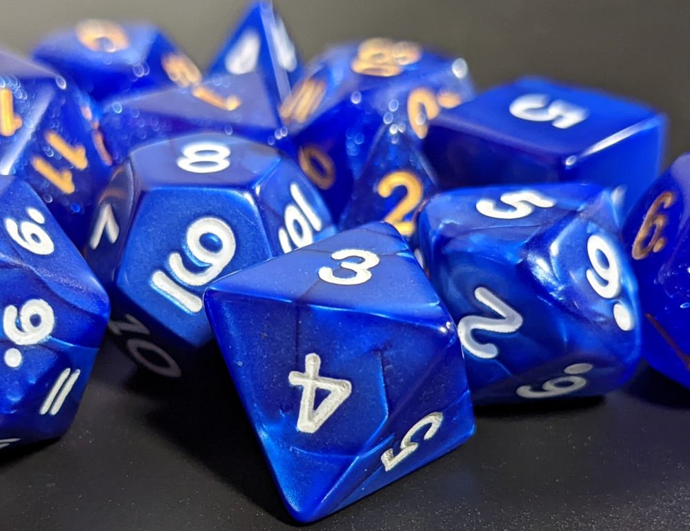 a jumble of blue dice for playing Dungeons and Dragons