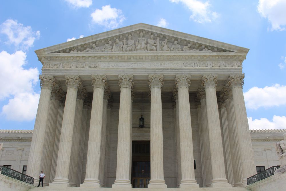 Photo of the front entrance of the United States Supreme Court building in Washington D.C. with the inscription Equal justice under law engraved above on the West Pediment, 2016, by Claire Anderson on Unsplash.