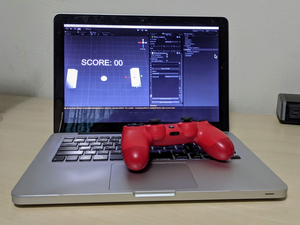 Programming Pong via Unity screenshot by Andre Infante via makeuseof, 2017. Photo of MacBook Pro laptop and red Playstation game controller by Nic Rosenau, 2021