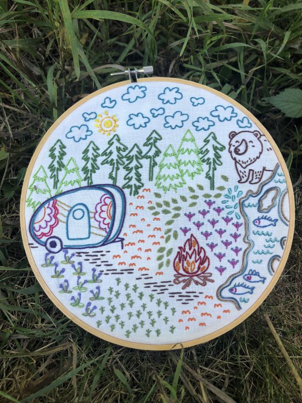 Embroidery in a hoop illustrating a camping trip.