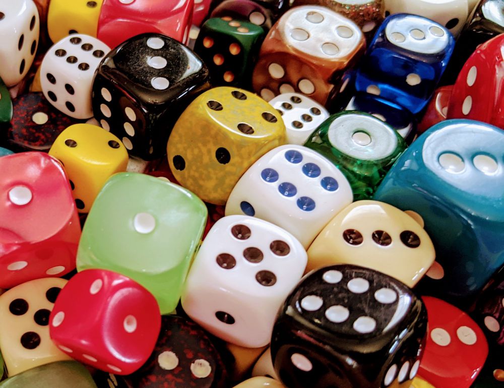 A jumble of dice of different sizes and colors.