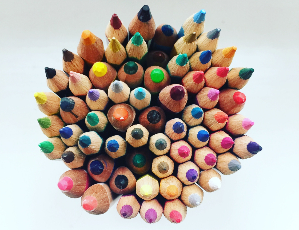 A top-down photo of a bundle of sharpened colored pencils.