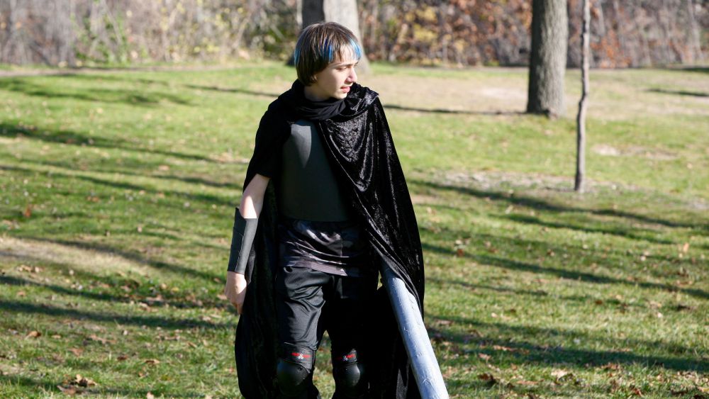 A young LARPer partially outfitted in foamsmithed armor while LARPing at Silverwood Park in Saint Anthony Village, Minnesota, USA.