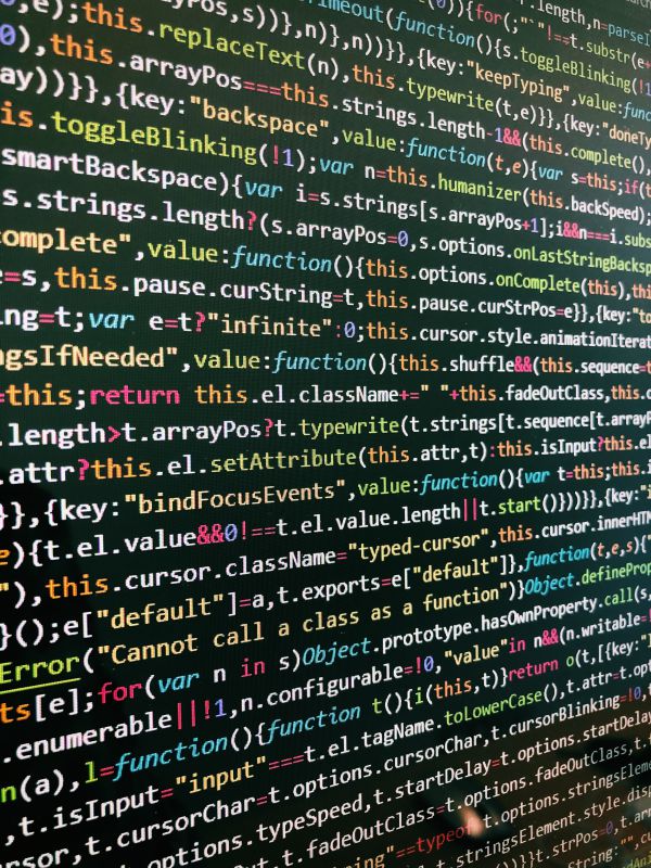Photo of multicolored code on a computer screen, 2019, by Roozbeh Eslami on Unsplash.
