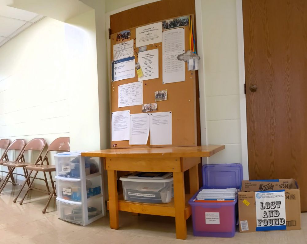 onsite volunteer station with bench, bulletin board, cart, file box, and folding chairs