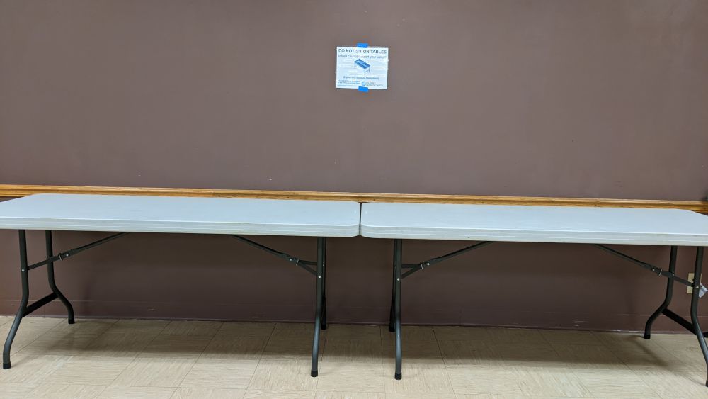 Do not sit on tables sign over tables in the Fellowship Hall