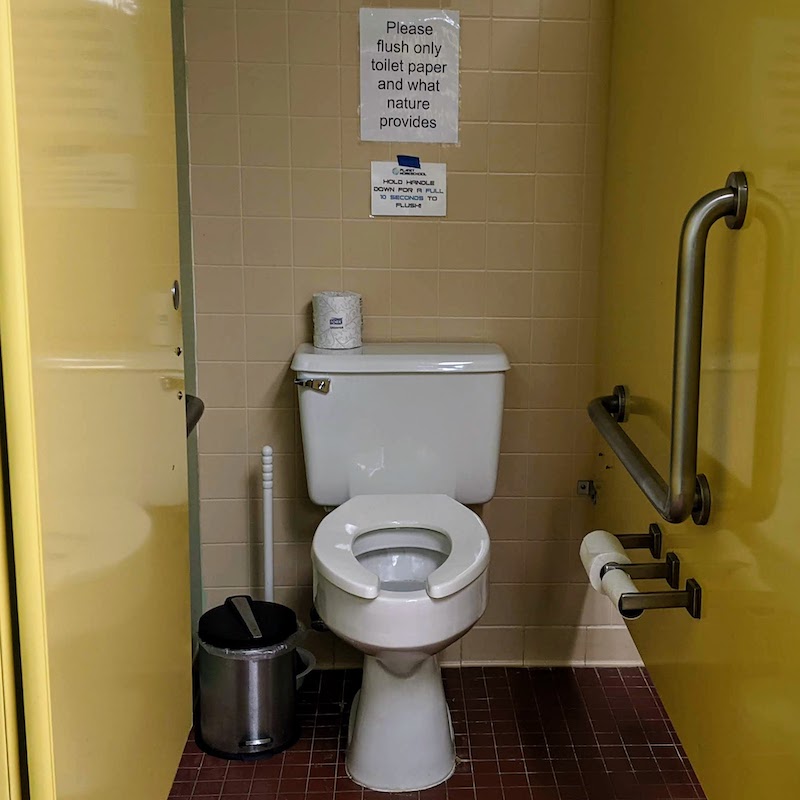 hold 10 seconds to flush in the south stall of the east restroom