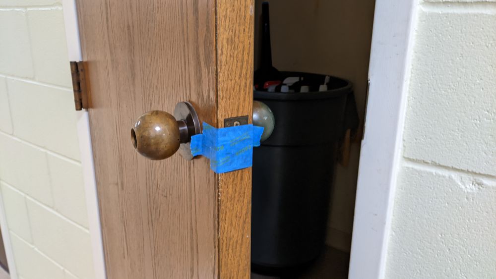 blue tape over the Utility Closet Latch, door open